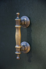 Ancient door handle on a wooden door in Venice, Italy