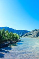Naklejka na ściany i meble Misty River Through a Forest. Stream in the wood. Beautiful natural scenery of river in the forest. Mountain valley. Peaceful summer nature background. Mountain river water landscape. Altai mountain