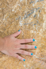 Woman hand touch on the stone
