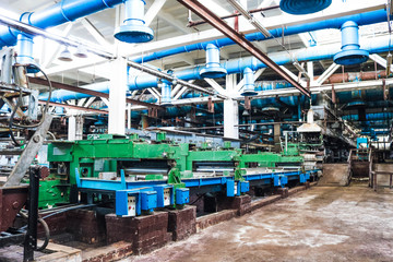 Metal industrial powerful equipment of the production department at the machine-building oil refining, petrochemical, chemical plant with tubing machines with hoses and flanges