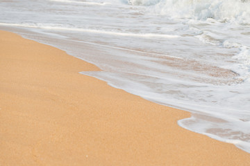 Soft foam wave and sea on the sandy beach