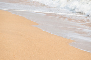 Soft foam wave and sea on the sandy beach