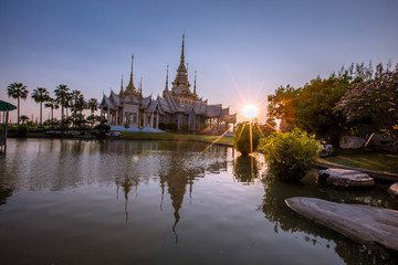 Fototapeta na wymiar Wallpaper Wat Lan Boon Mahawihan Somdet Phra Buddhacharn(Wat Non Kum)is the beauty of the church that reflects the surface of the water, popular tourists come to make merit and take a public photo 