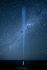 Flashlight lighting in the dark sky crossing southern Milky Way, star gazing night photography...