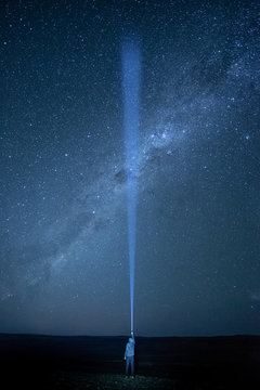 Flashlight lighting in the dark sky crossing southern Milky Way, star gazing night photography concept