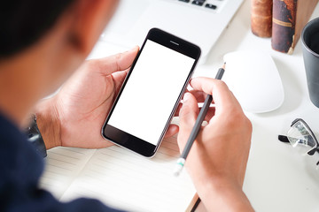 Cropped shot view of man hands holding smart phone with blank copy space screen for your text message or information content, female reading text message on cell telephone during in urban setting.