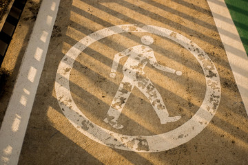 White walking symbol on walking street.
