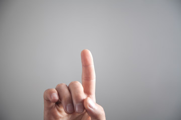 Male hand pointing or touching finger in screen.
