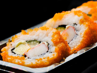 Sushi maki california roll are mood tone color orange. repeat pattern japanese food