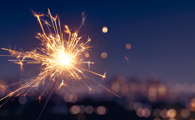 Sparkler with blurred city light background