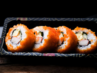 Sushi maki california roll are mood tone color orange. repeat pattern japanese food