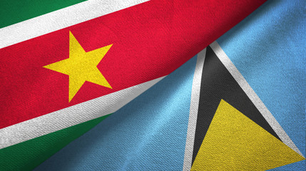 Fototapeta premium Suriname and Saint Lucia two flags textile cloth, fabric texture