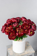 Red peonies in a metal vase. Beautiful peony flower for catalog or online store. Floral shop concept . Beautiful fresh cut bouquet. Flowers delivery
