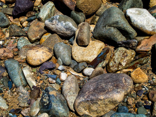 Stones on the ground. Rock background. Ground and stones. Rocky soil. Stone background. Natural