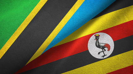 Fototapeta premium Tanzania and Uganda two flags textile cloth, fabric texture