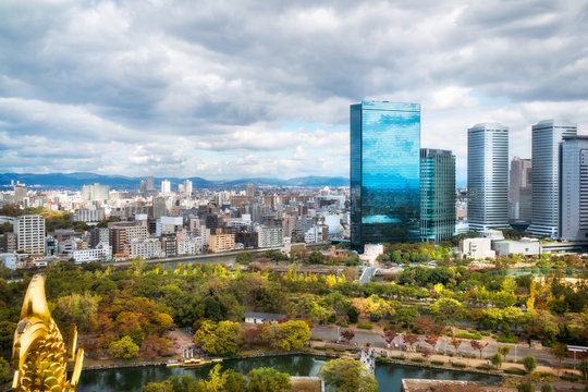 Panoramic view of Osaka business district and mountains surrounding the Osaka City, Osaka Castle Park and City Skyline, with Crystal Tower as one of the prominent buildings, in Japan.