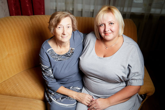 Elderly grandmother and her adult daughter in the room