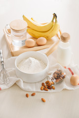 Obraz na płótnie Canvas ingredients and tools to make banana cake on white background