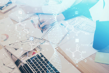 DNA theme hologram over woman's hands writing background. Concept of education. Double exposure