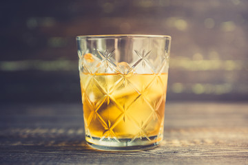Old fahioned cocktail on the rustic background. Selective focus. Shallow depth of field.