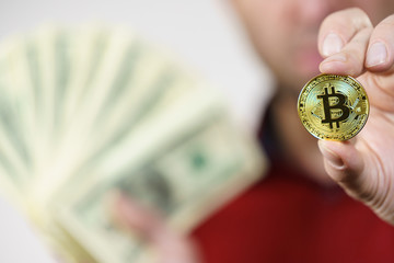 Man having bitcoin coin and cash