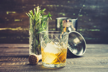 Old fahioned cocktail on the rustic background. Selective focus. Shallow depth of field.