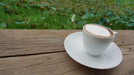 cup of coffee on wooden table