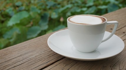 cup of coffee on wooden table