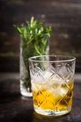 Old fahioned cocktail on the rustic background. Selective focus. Shallow depth of field.