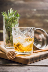 Old fahioned cocktail on the rustic background. Selective focus. Shallow depth of field.
