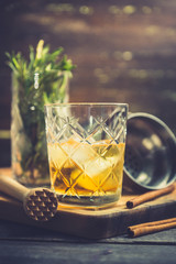 Old fahioned cocktail on the rustic background. Selective focus. Shallow depth of field.