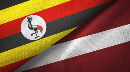 Fototapeta premium Uganda and Latvia two flags textile cloth, fabric texture