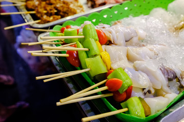 Various types of meat such as squid, pork, chicken, beef and vegetables are skewed for roasting. Placed for customers to choose to buy Is a street food that can be seen in Thailand
