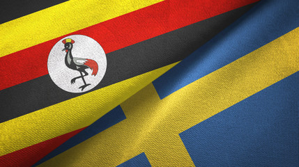 Fototapeta premium Uganda and Sweden two flags textile cloth, fabric texture