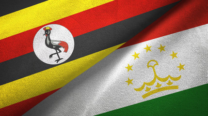 Fototapeta premium Uganda and Tajikistan two flags textile cloth, fabric texture