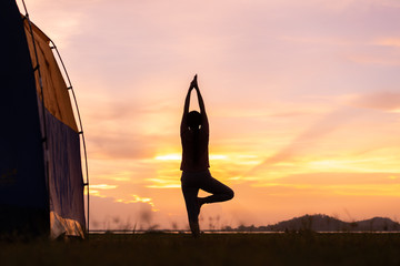 Asian young woman exercise and practice yoga in sunset the relax nature background.