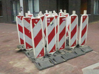 in company, group of warning signs standing on the sidewalk