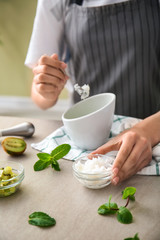 Woman preparing body scrub at table