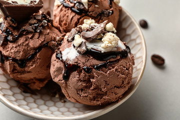 Bowl with tasty ice cream on light background, closeup