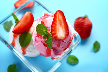 Bowl with tasty strawberry ice cream on color background