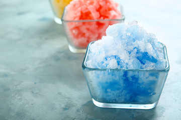 Bowl with tasty shaved ice on color background