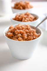Bowls with tasty shaved ice on white table