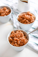 Bowls with tasty shaved ice on white table
