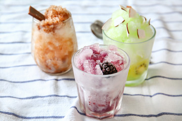 Assortment of tasty shaved ice on table