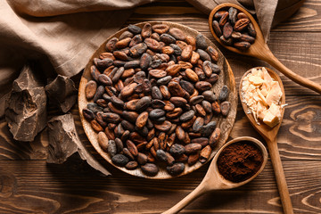 Composition with cocoa beans on wooden table