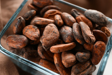 Bowl with cocoa beans, closeup