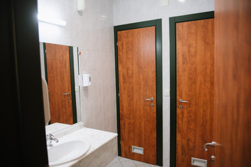 Bathroom in the apartment with white marble tiles with bath, toilet and wash basin