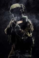 russian special forces soldier with rifle on dark background. army, military and people concept