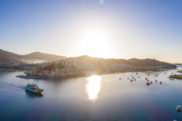 ship is on the water near the island of Poros Greece. Beautiful sunrise morning moment. Travel inspiration