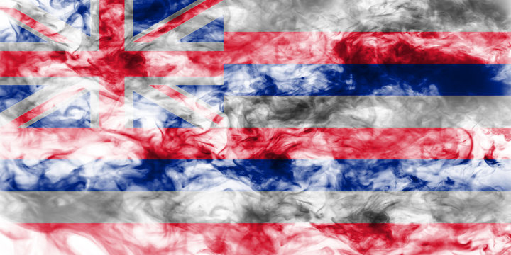 The national flag of the US state Hawaii in against a gray smoke on the day of independence in different colors of blue red and yellow. Political and religious disputes, customs and delivery.